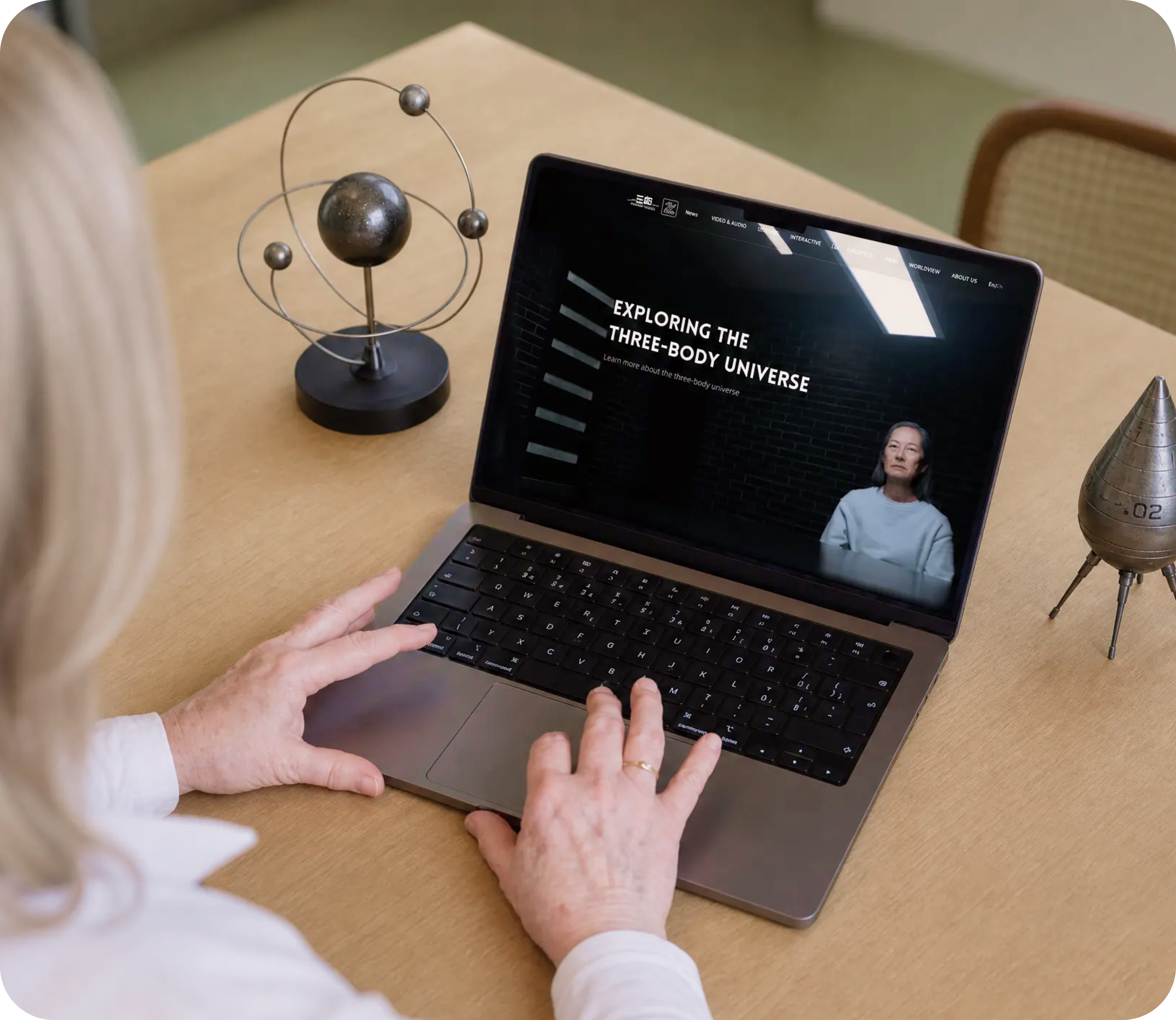 The Three-Body official website shown on a laptop